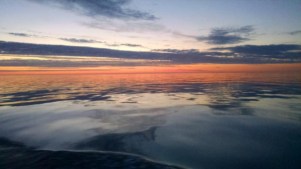 A sunset over a glassy lake