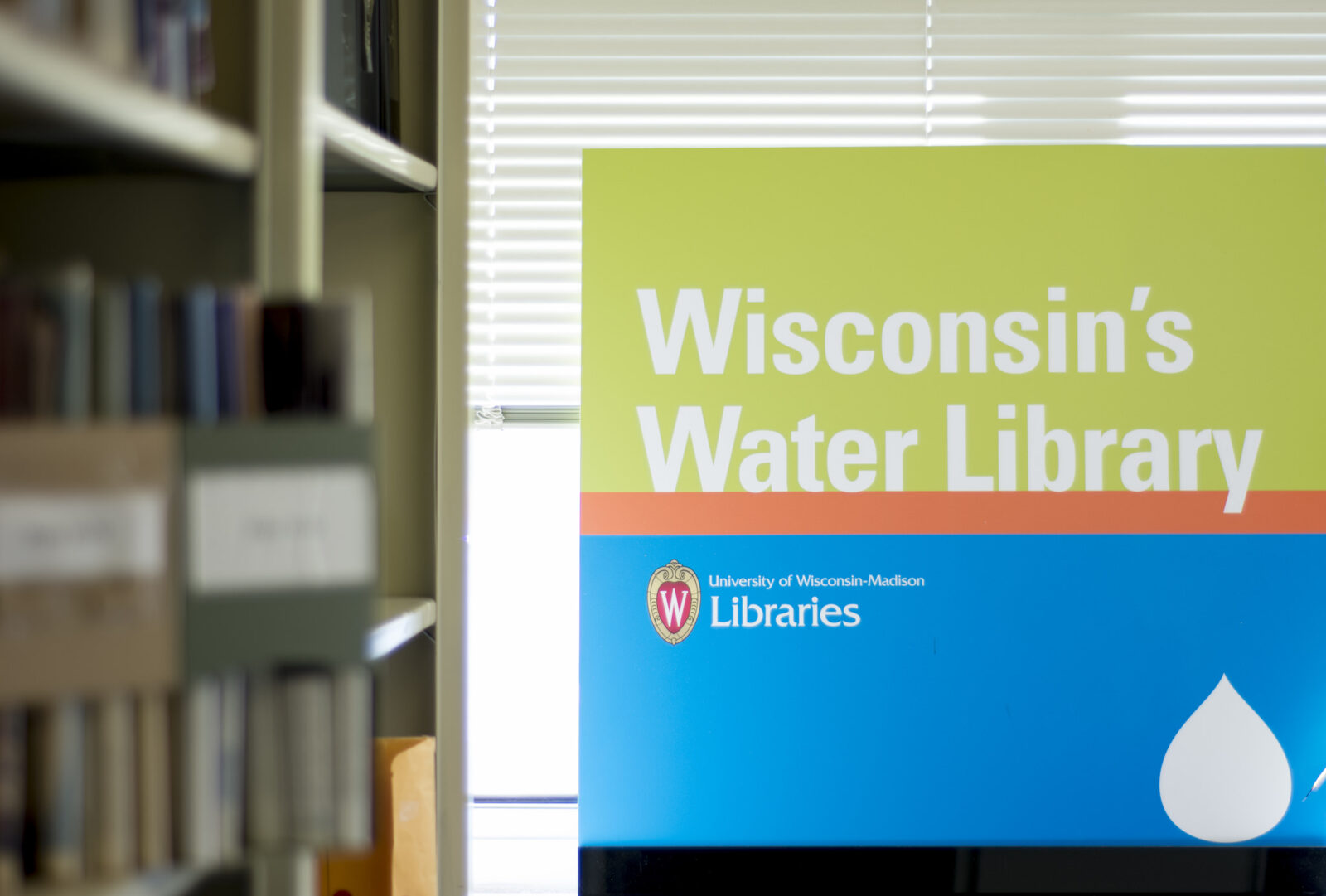 A sign that says "Wisconsin's Water Library" in a window