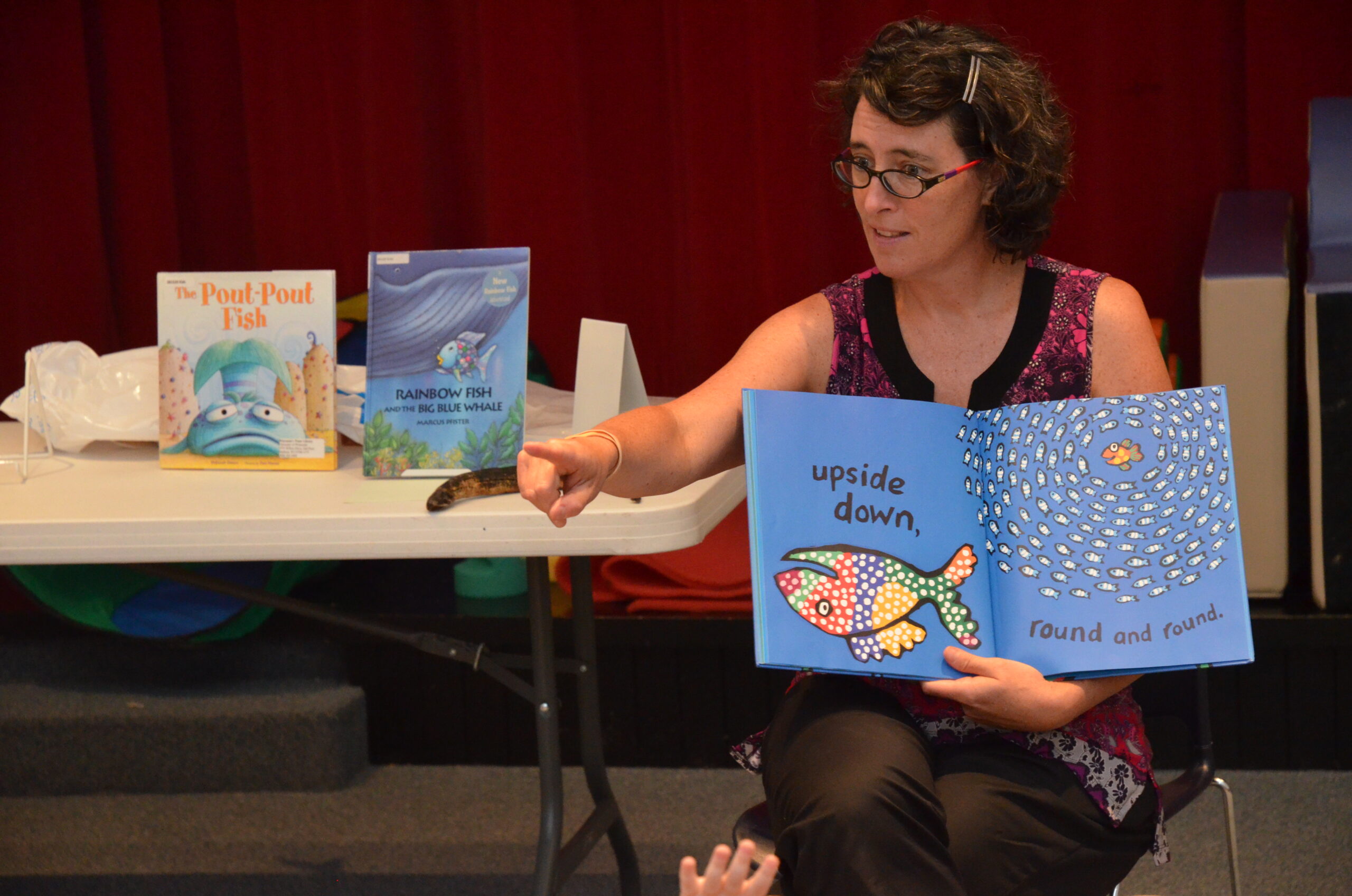 Anne Moser reads a picture book at a storytime